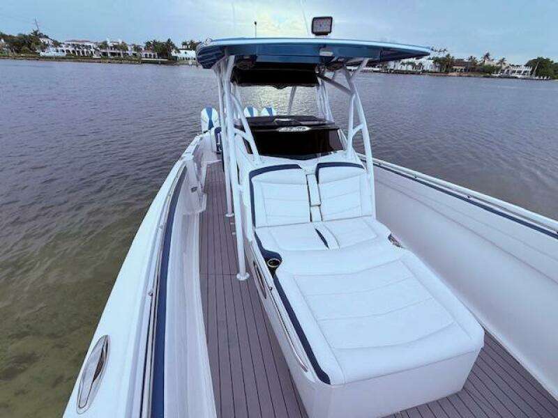 2022 Nor-Tech 390 Sport Center Console boat with sleek design on calm water.