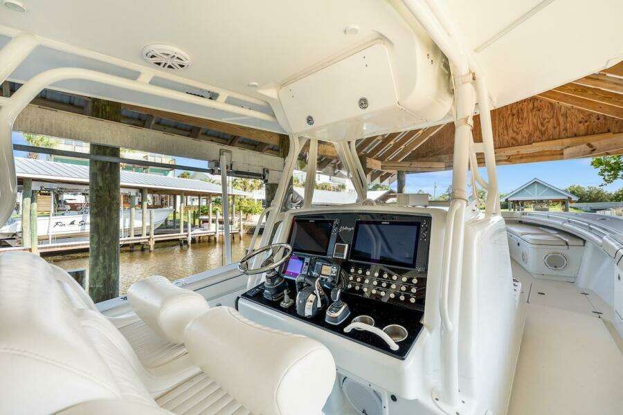 2015 Yellowfin 39 boat cockpit with advanced navigation system and luxurious white seating.