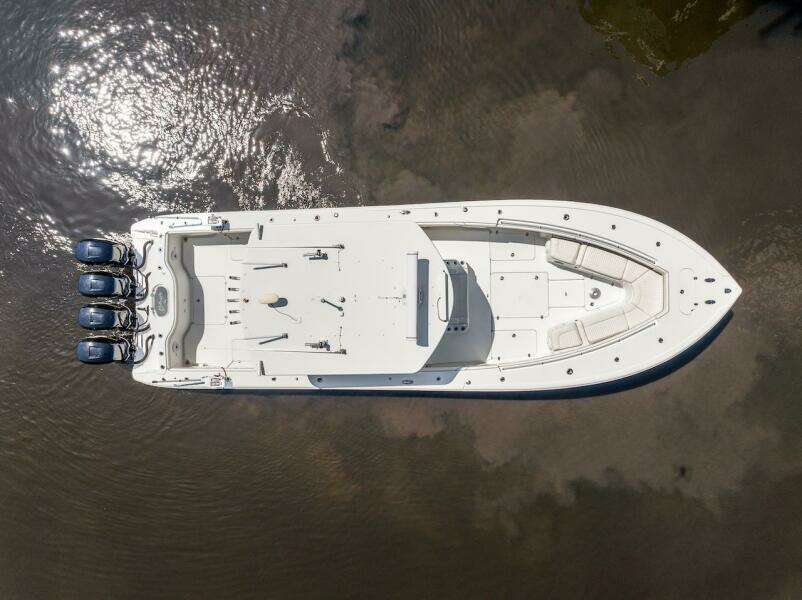 Aerial view of 2015 Yellowfin 39 boat with triple engines on calm water.