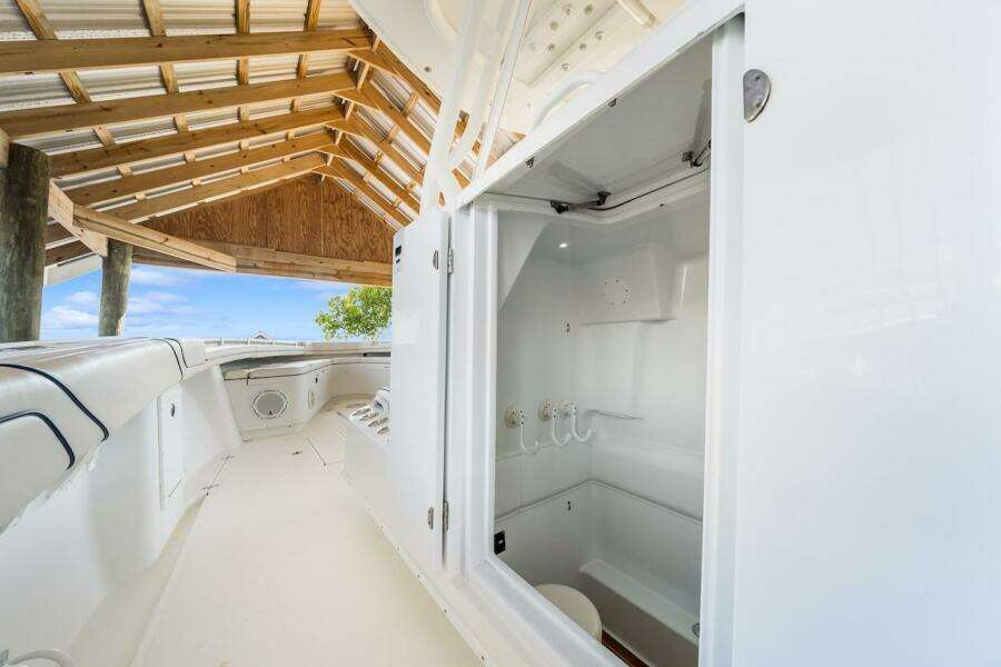 2015 Yellowfin 39 boat interior with open storage compartment under a wooden canopy.