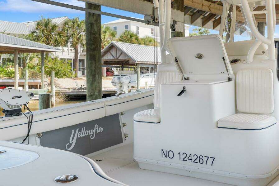 2015 Yellowfin 39 boat interior with seating and storage, docked at a marina.