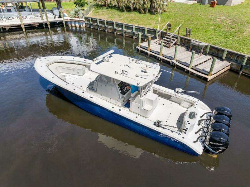 2015 Yellowfin 39 boat with quad Mercury engines docked in a canal.