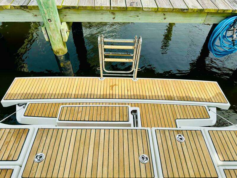 Teak swim platform on 2015 Beneteau Oceanis 45 yacht, dockside view.