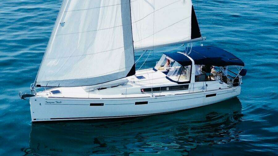 2015 Beneteau Oceanis 45 sailing yacht on calm blue waters.