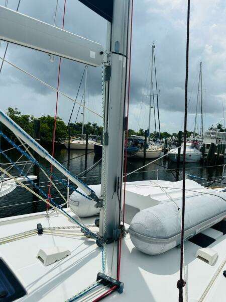 2015 Beneteau Oceanis 45 sailboat docked, featuring mast and rigging, with cloudy sky backdrop.
