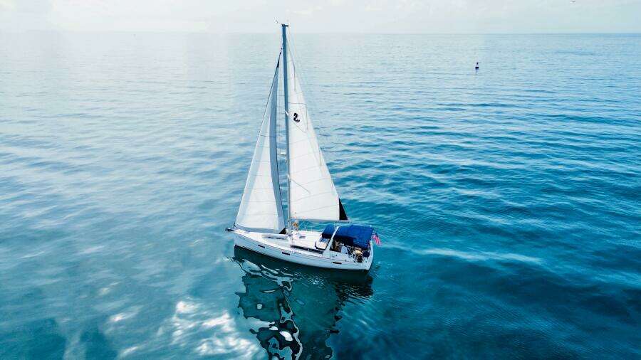 Sailing yacht Beneteau Oceanis 45, 2015 model, gliding on calm blue waters.