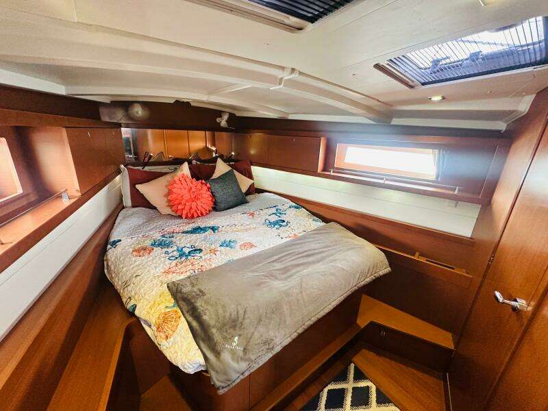 Luxurious cabin interior of 2015 Beneteau Oceanis 45 sailboat with cozy bedding.