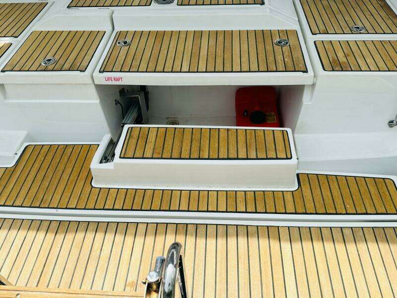 Teak deck of 2015 Beneteau Oceanis 45 sailboat with life raft compartment.
