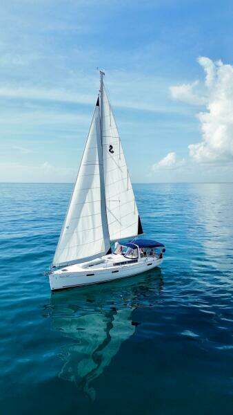 Beneteau Oceanis 45 sailboat from 2015 on calm blue ocean under clear sky.
