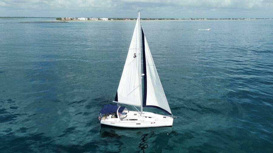 Sailing yacht Beneteau Oceanis 45, 2015 model, cruising on calm blue waters.
