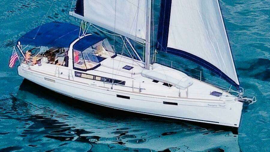 2015 Beneteau Oceanis 45 sailboat cruising on clear blue water.
