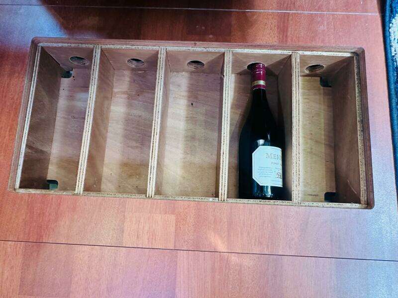 Wine storage compartment on 2015 Beneteau Oceanis 45 yacht, featuring a single wine bottle.