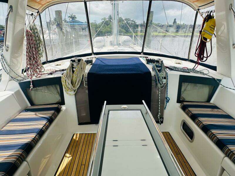 Interior view of 2015 Beneteau Oceanis 45 sailboat cockpit with striped seating and nautical ropes.