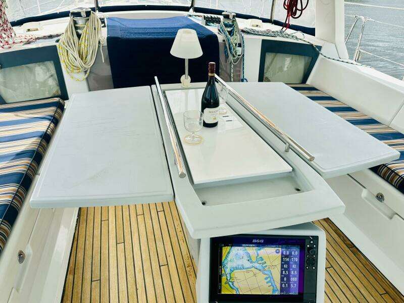 Beneteau Oceanis 45 cockpit with table, wine, and navigation display, 2015 model.