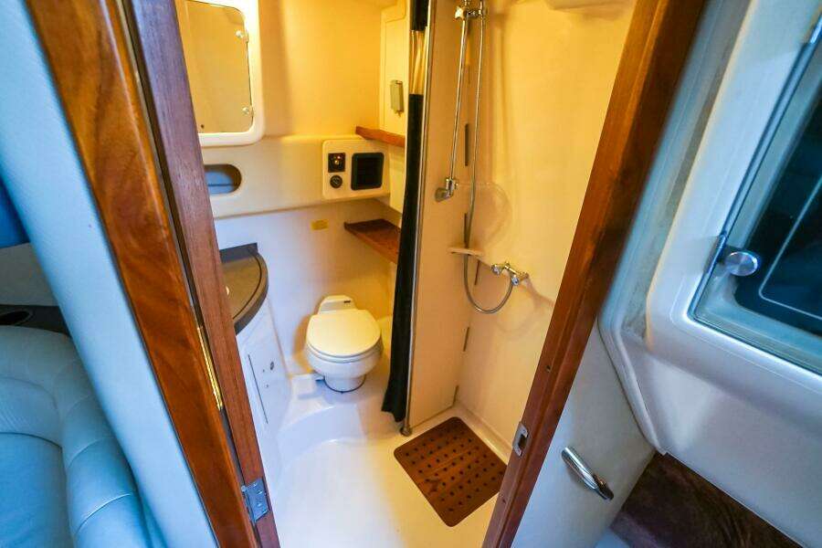 2007 Grady-White Express 360 boat bathroom with shower, toilet, and wooden accents.