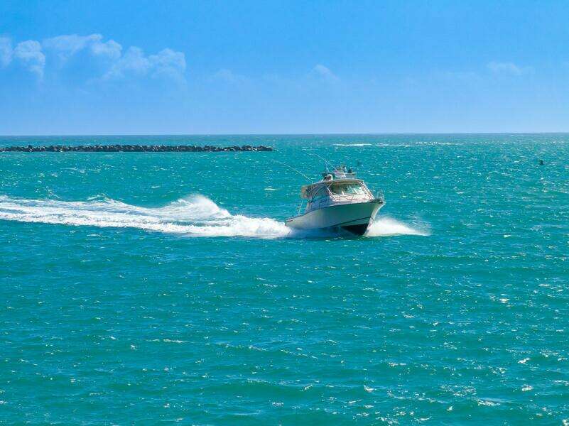 2007 Grady-White Express 360 boat cruising on turquoise ocean waters.