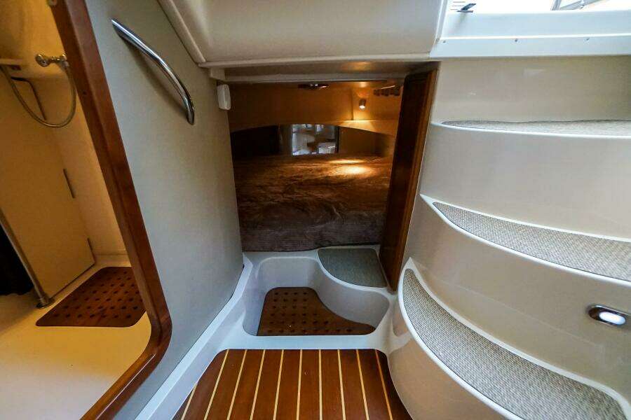 2007 Grady-White Express 360 cabin interior with stairs and cozy sleeping area.