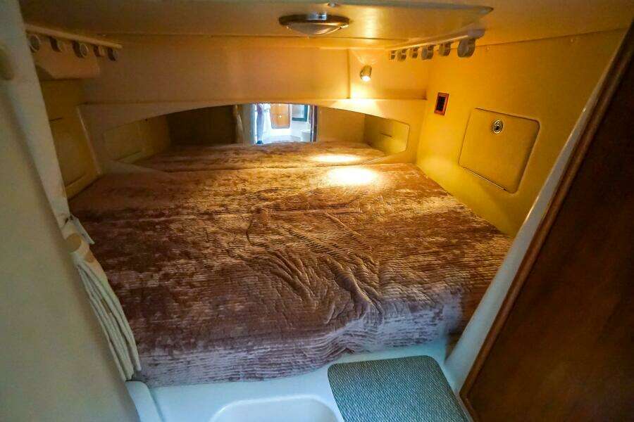 2007 Grady-White Express 360 cabin interior with cozy bed and warm lighting.