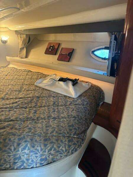 Interior cabin of a 2007 Monterey 350 Sport Yacht with cozy bedding and decor.