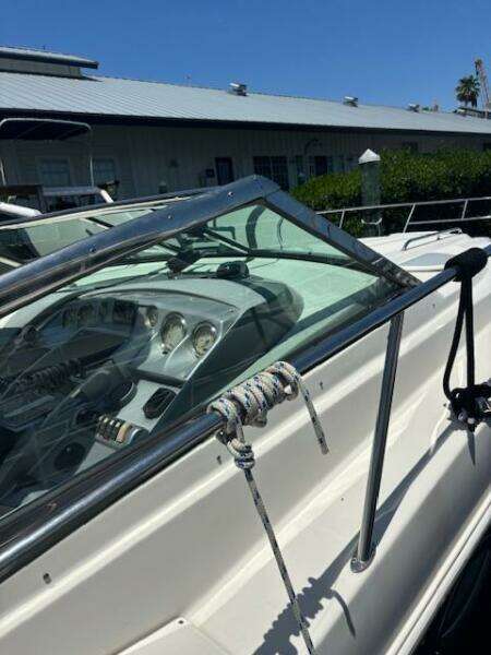 2007 Monterey 350 Sport Yacht with sleek dashboard and mooring rope, docked under clear blue sky.