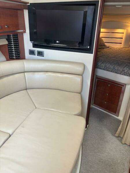 Interior of 2007 Monterey 350 Sport Yacht with leather seating and flat-screen TV.