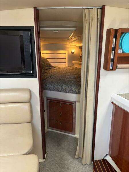 Interior of 2007 Monterey 350 Sport Yacht with cozy bedroom and modern amenities.