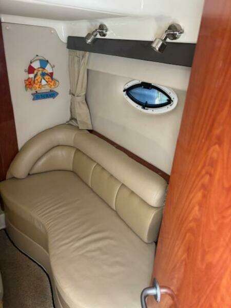 Interior of 2007 Monterey 350 Sport Yacht with beige leather seating and porthole window.