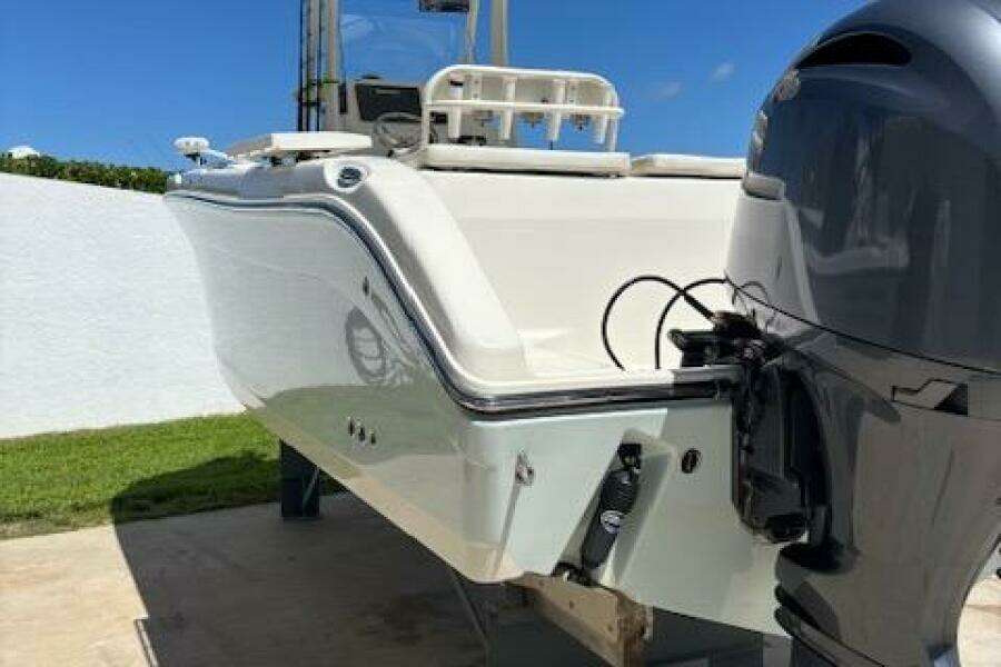 2018 Century 2600 Center Console boat with outboard motor, docked outdoors.