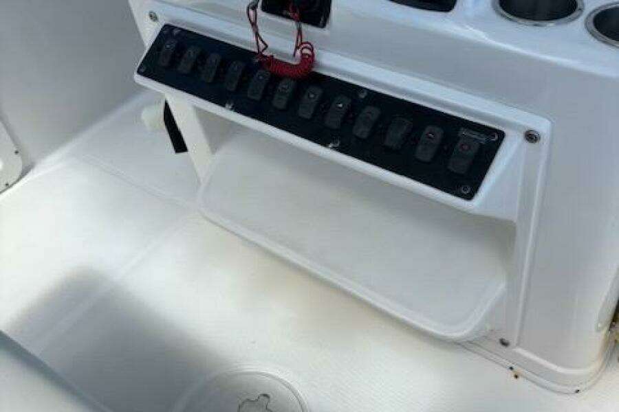 Century 2600 Center Console 2018 boat dashboard with control panel and cup holders.
