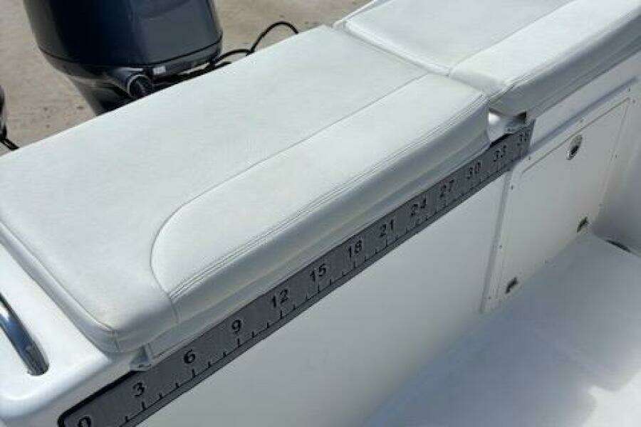 2018 Century 2600 Center Console boat with cushioned seating and built-in measuring ruler.