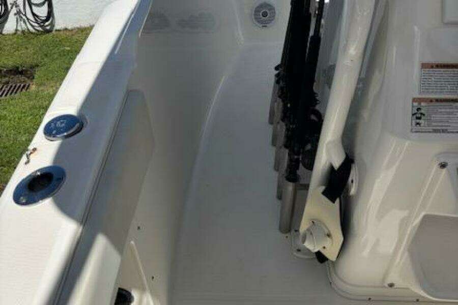 2018 Century 2600 Center Console boat interior with rod holders and seating area.