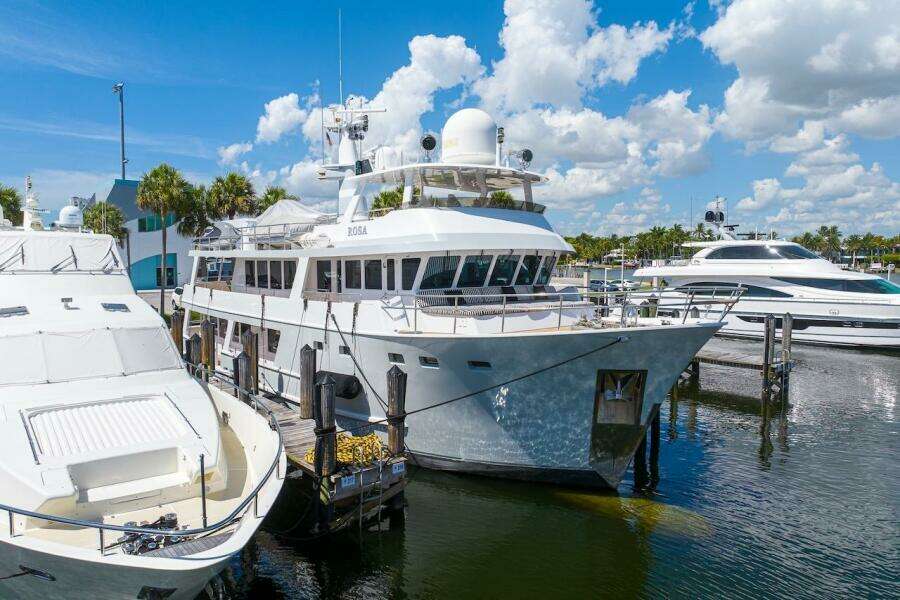 Luxury yacht ABD 90 Explorer 1996 docked at marina under blue sky.