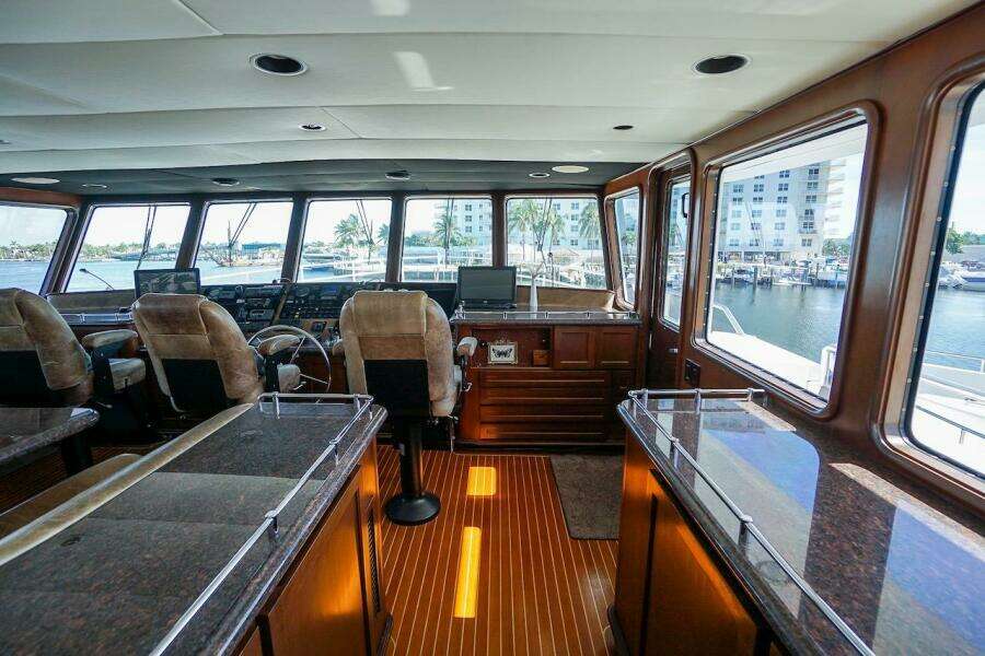 Luxurious interior of 1996 ABD 90 Explorer yacht with panoramic windows and plush seating.