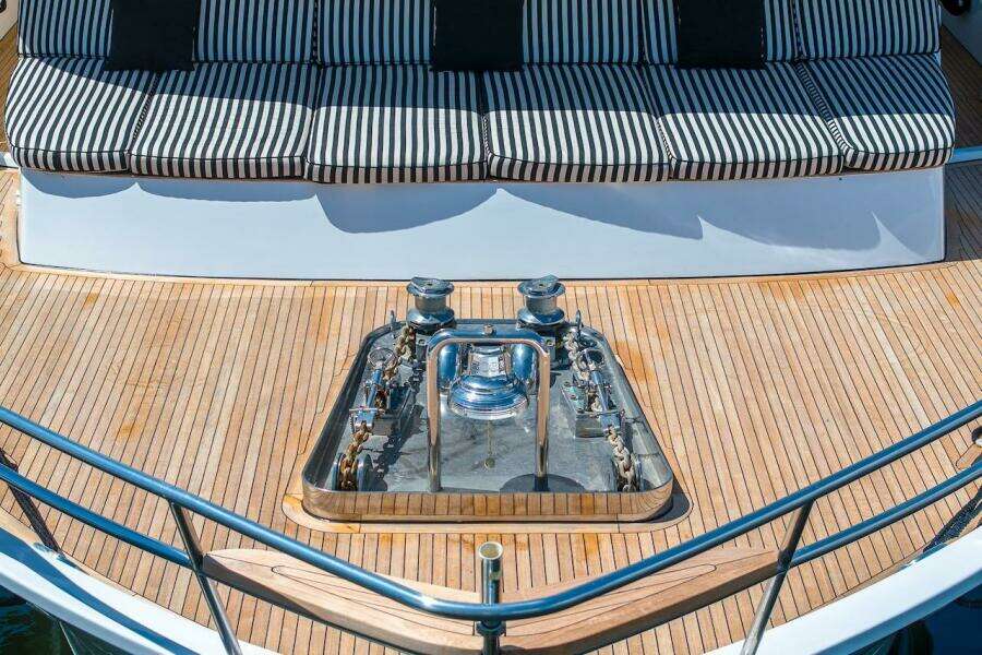 Deck of 1996 ABD 90 Explorer yacht with striped seating and anchor equipment.