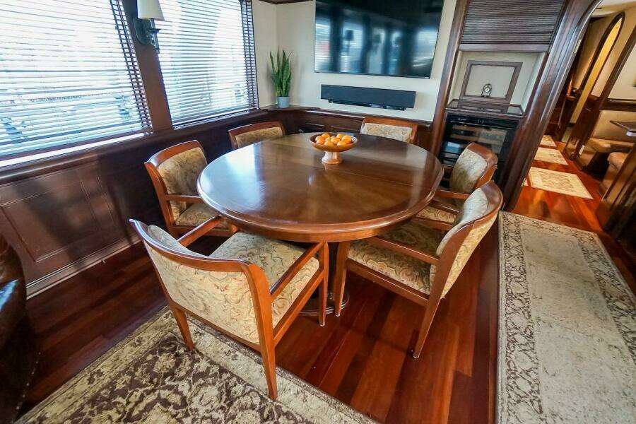 Luxurious dining area in 1996 ABD 90 Explorer yacht with elegant wooden table and chairs.