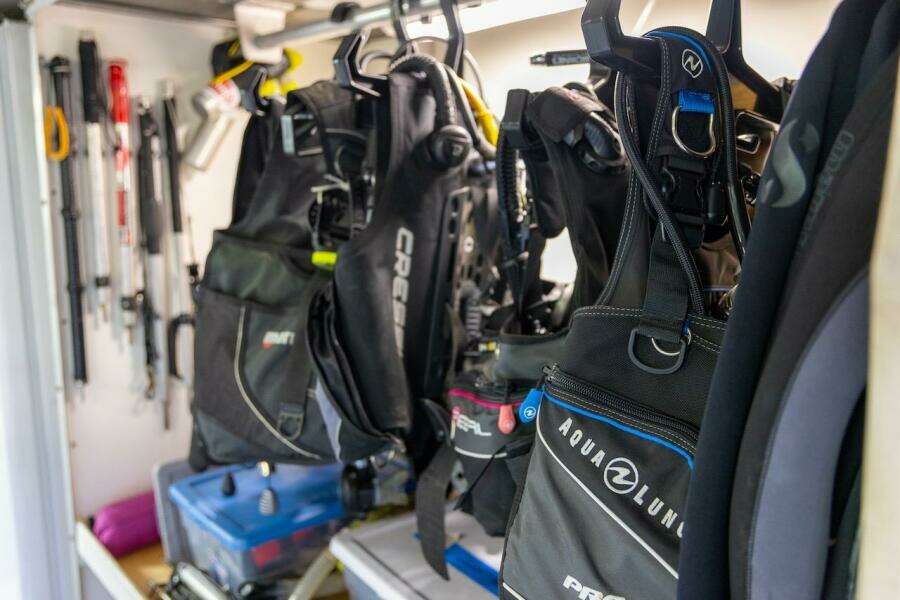 Diving gear storage with wetsuits and equipment in a well-organized space.