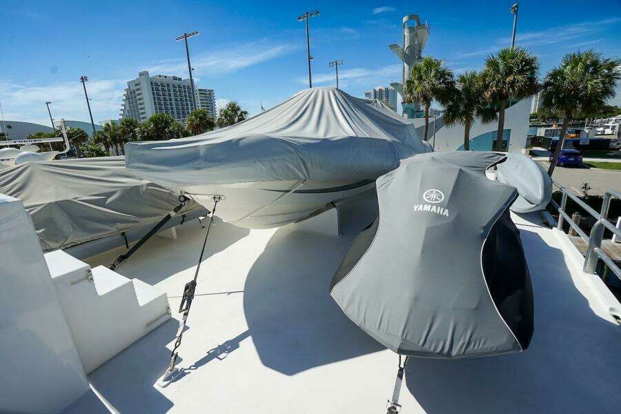 Luxury yacht ABD 90 Explorer 1996 docked by waterfront buildings under blue sky.