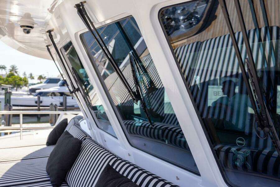 Luxury yacht with striped seating, featuring sleek windows and modern design elements.