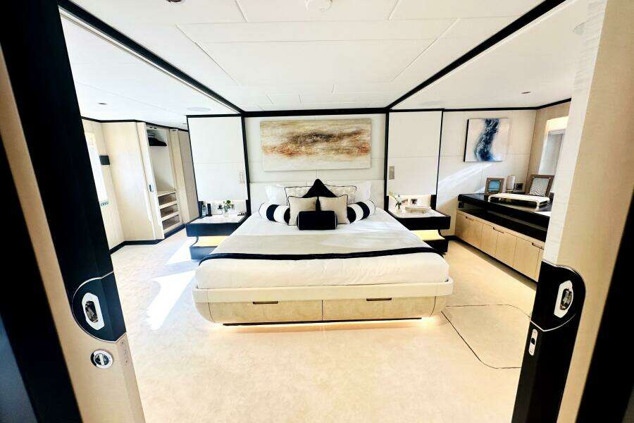 Luxurious 2023 Majesty 120 yacht bedroom with modern decor and elegant furnishings.