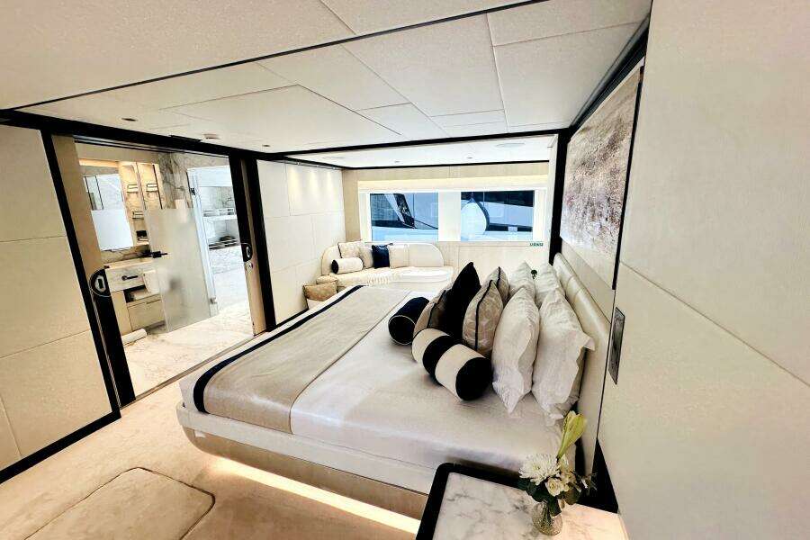 Luxurious bedroom interior of 2023 Majesty 120 yacht with modern design and elegant decor.