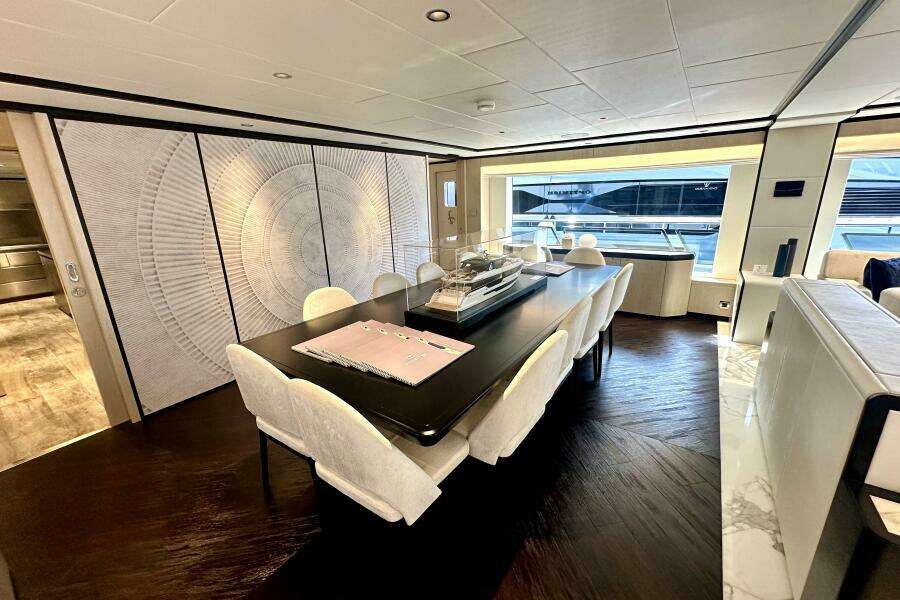 Luxurious interior of 2023 Majesty 120 yacht with elegant dining area and modern decor.