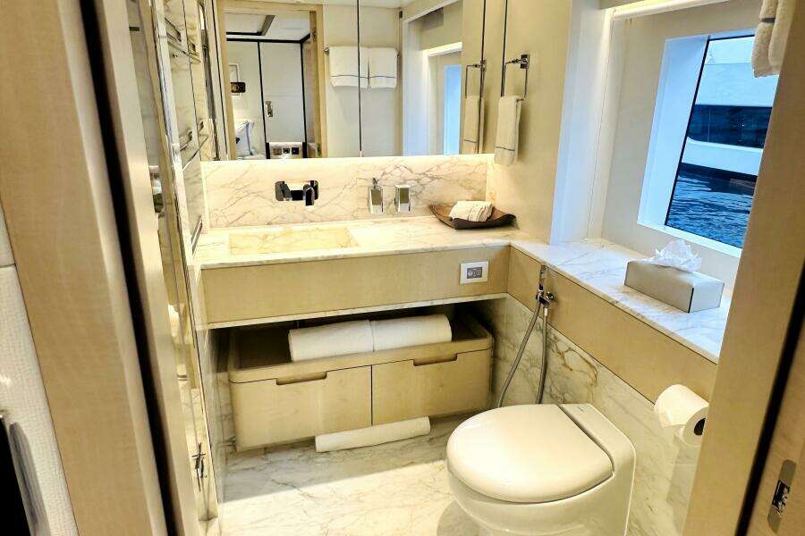 Luxurious 2023 Majesty 120 yacht bathroom with marble accents and modern fixtures.