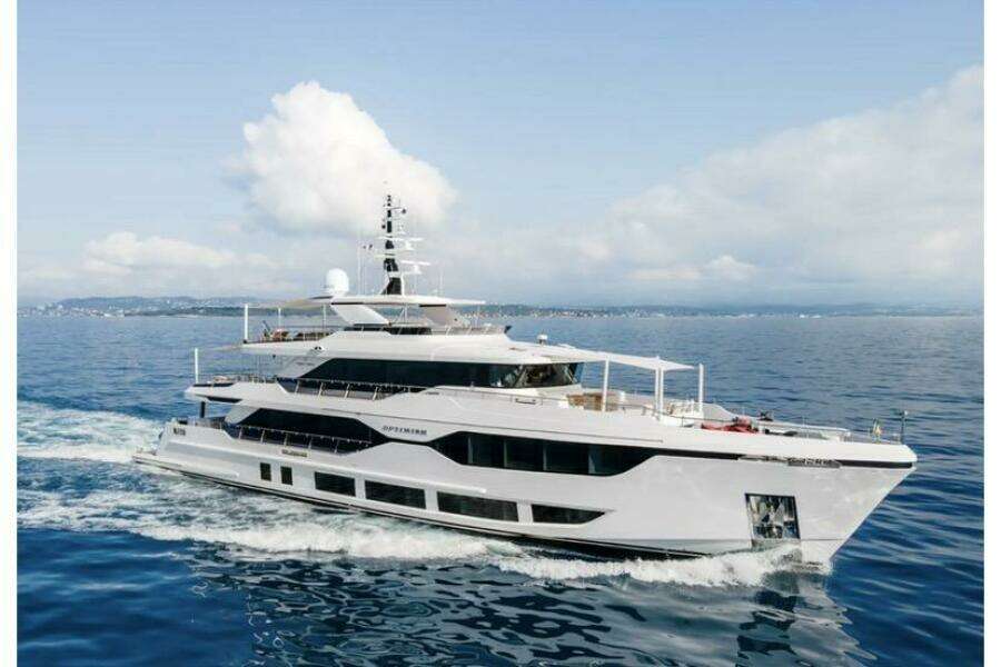 Luxurious 2023 Majesty 120 yacht cruising on open sea under clear skies.