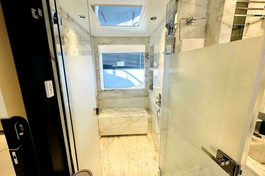 Luxurious marble bathroom in 2023 Majesty 120 yacht, featuring modern fixtures and natural light.