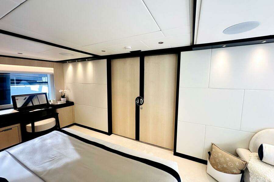 Luxurious 2023 Majesty 120 yacht bedroom with modern decor and elegant furnishings.
