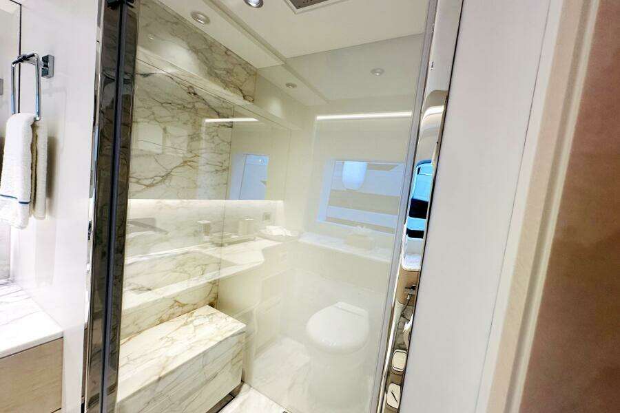 Luxurious bathroom with marble accents in 2023 Majesty 120 yacht.