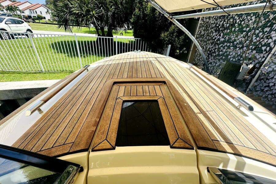 2013 Chris-Craft Corsair 22 boat with sleek wooden deck design.