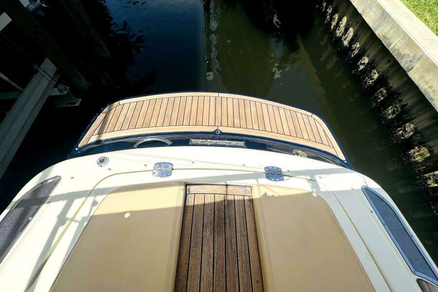 2013 Chris-Craft Corsair 22 boat with teak deck, docked in calm water.
