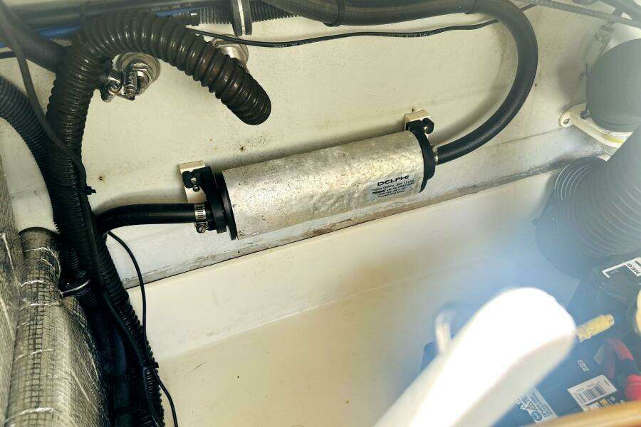 Engine compartment of 2013 Chris-Craft Corsair 22 with visible hoses and components.