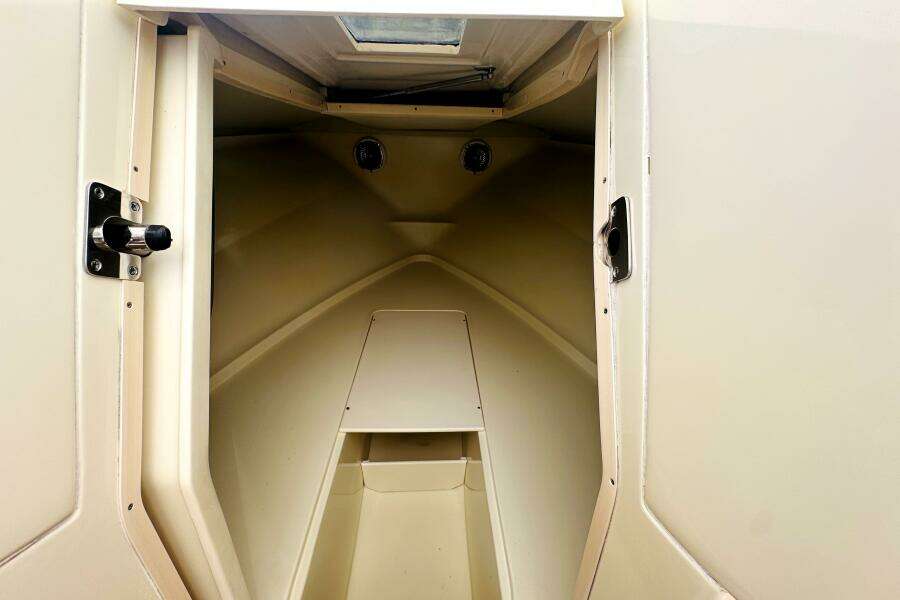 2013 Chris-Craft Corsair 22 cabin interior, featuring a compact, beige design.